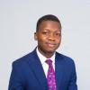 Dami Akinneye in blue suit with purple tie