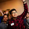 alumni raise hands to be recognized at celebration