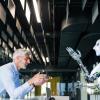 A man and a robot talking to each other 