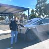 Ben Mousseau standing next to a Tesla