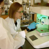 Morgan Riffe (left), a PhD candidate in Materials Science & Engineering, looks on while Meg Cooke, PhD, research associate in the BioFrontiers Institute, points to 3D printing biomaterial scaffolds that use an extrusion printer. 