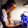 A student working in the lab with lasers