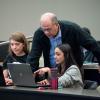 David Clough helping students in classroom