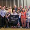 Clough and alumni with banner