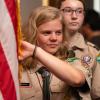 Emerson Domke in scout uniform holding flag