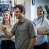 A chemical engineering instructor works with two female students in a lab.