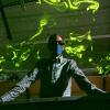 Professor John Crimaldi looking over water and lasers in his lab