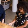 A student works with her faculty mentor in a robotics lab. 