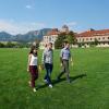 Graduate students walk across field on campus