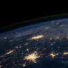 A view of the Earth from space, showing clusters of lights in cities.