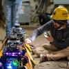 Harlow inspecting one of the robots before activation.