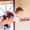 A dad and child touching the AC