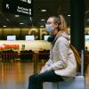 girl in airport wearing mask