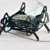 HAMR-Jr poses next to a cockroach