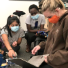 CU Boulder students Halle Sago, Ryan Carroll and Sylvia Akol discuss data input for built environment surveys in Denver high school classrooms.