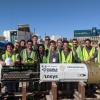 CU Hyperloop team members pose for a photo with their boring machine in Las Vegas