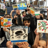 Students holding their art work