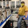 Tobias Niederwieser and Alexander Hoehn in a BioServe laboratory with five FRDIGE units slated for delivery to NASA and the International Space Station.