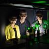Rafael Piestun and his students standing in a lab with a laser