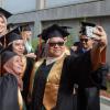 Female engineering students pose for a selfie at graduation