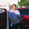 Cam Humphreys stands outside Tesla factory in California.