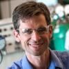 J. Will Medlin in the lab wearing blue shirt and safety glasses