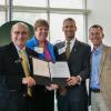 Phil DiStefano, Terri Fiez, Keoki Jackson, and Bobby Braun with the agreement.
