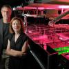 Physics professors Margaret Murnane and Henry Kapteyn of the Joint Institute for Laboratory Astrophysics (JILA) pose next to one of the laser apparatuses in their lab at the University of Colorado Boulder campus