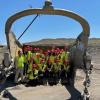 Students in hard hats with heavy equipment