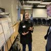 A research presents their poster to Acting Dean Keith Molenaar