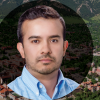 Poveda's headshot superimposed over an aerial shot of campus