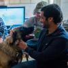 The team interacts with a real dog as part of their research. 