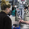 Male and female student work in mechanical lab