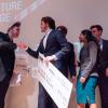 Tim Visos-Ely holds a giant check after winning the New Venture Challenge