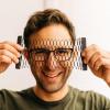Student with mesh item in front of face