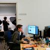 Three students working on creating content for the library