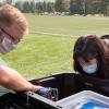 Cresten Mansfeldt and Katie Reeves examine a wastewater monitoring station that collects wastewater from the Kittredge residence hall complex.
