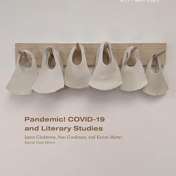 ceramic sculpture of six medical masks hanging in a row on wooden pegs