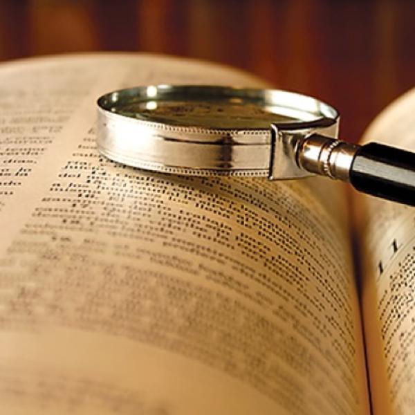 A magnifying glass on an open book