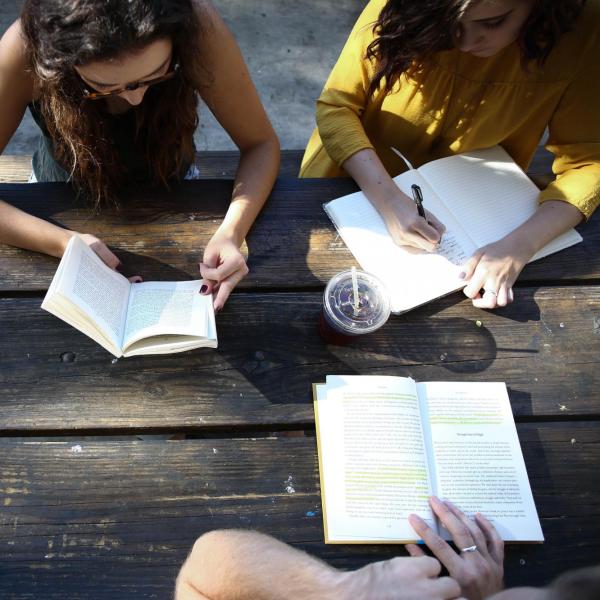 Three women working at a picnic table