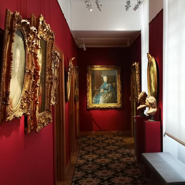 gold framed art on a red wall