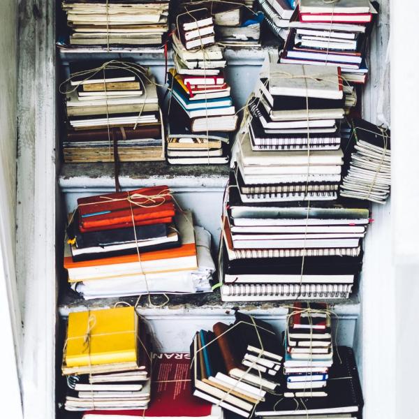 a bunch of books stacked in a stairwell