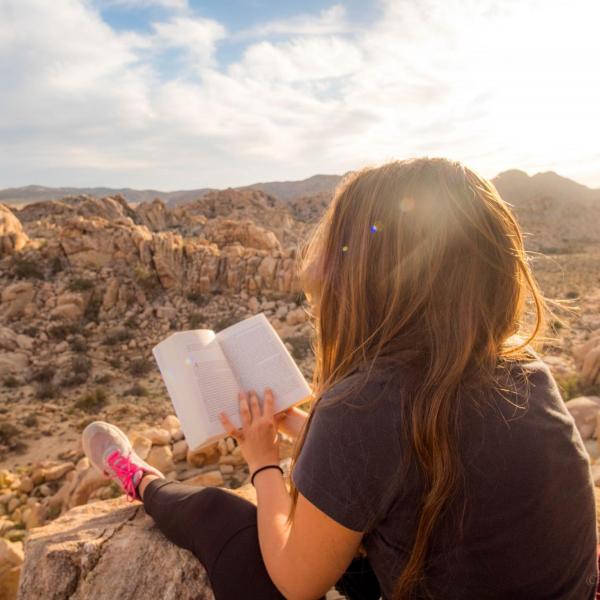 woman reading book outdoors