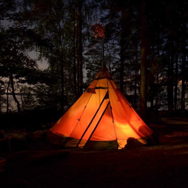 A tent lit up from the inside at night