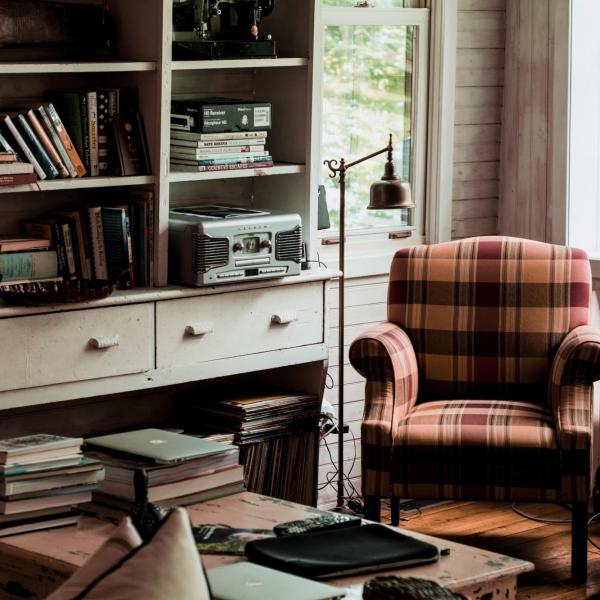 books on a table beside an armchair