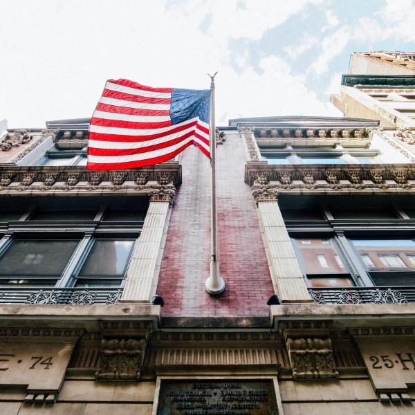 american flag flying over a building