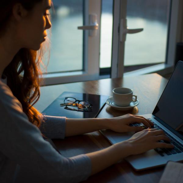 A woman at a table writing