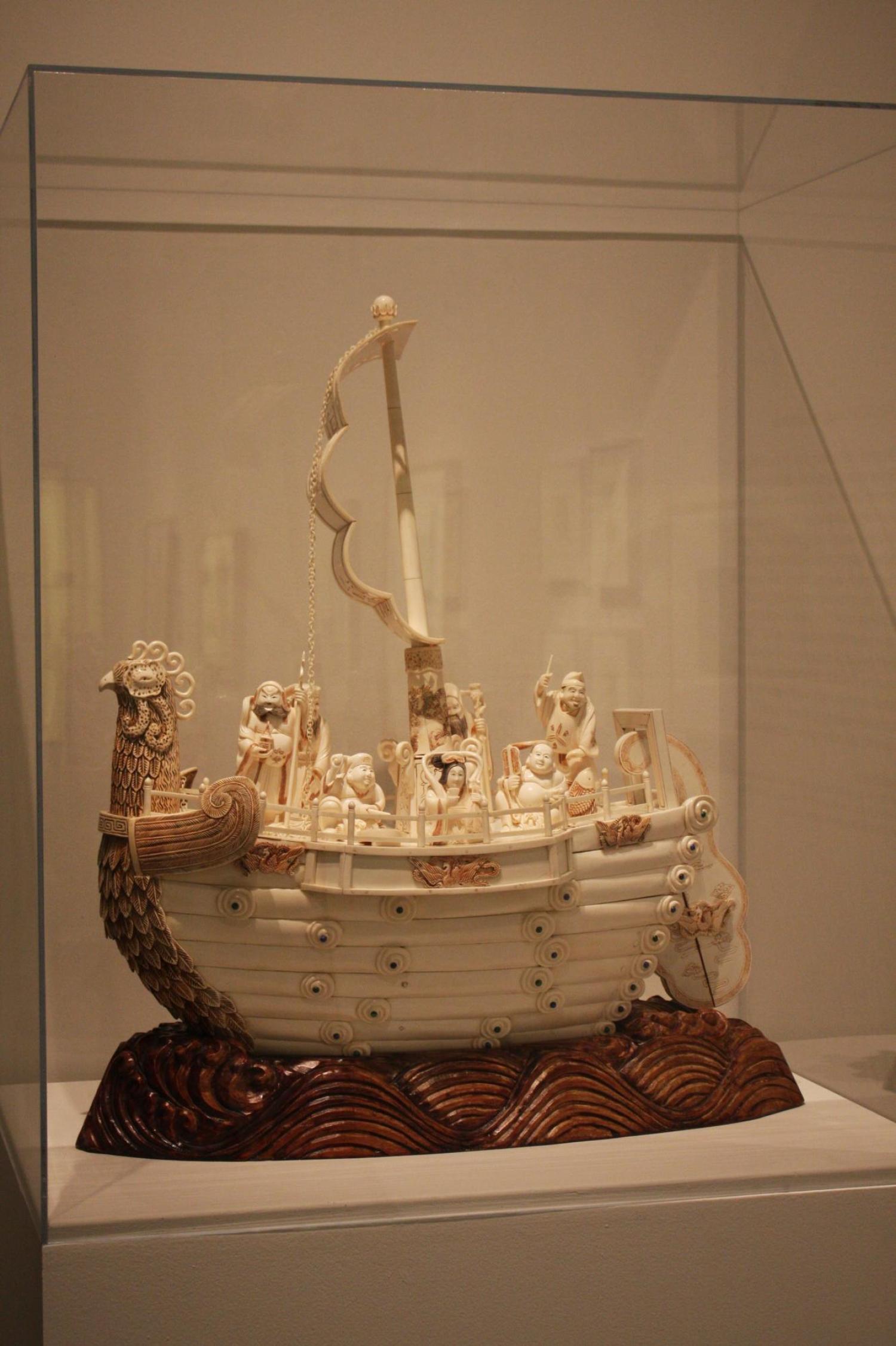 Art piece on display at the event. It's a wood or ivory carved ship. 