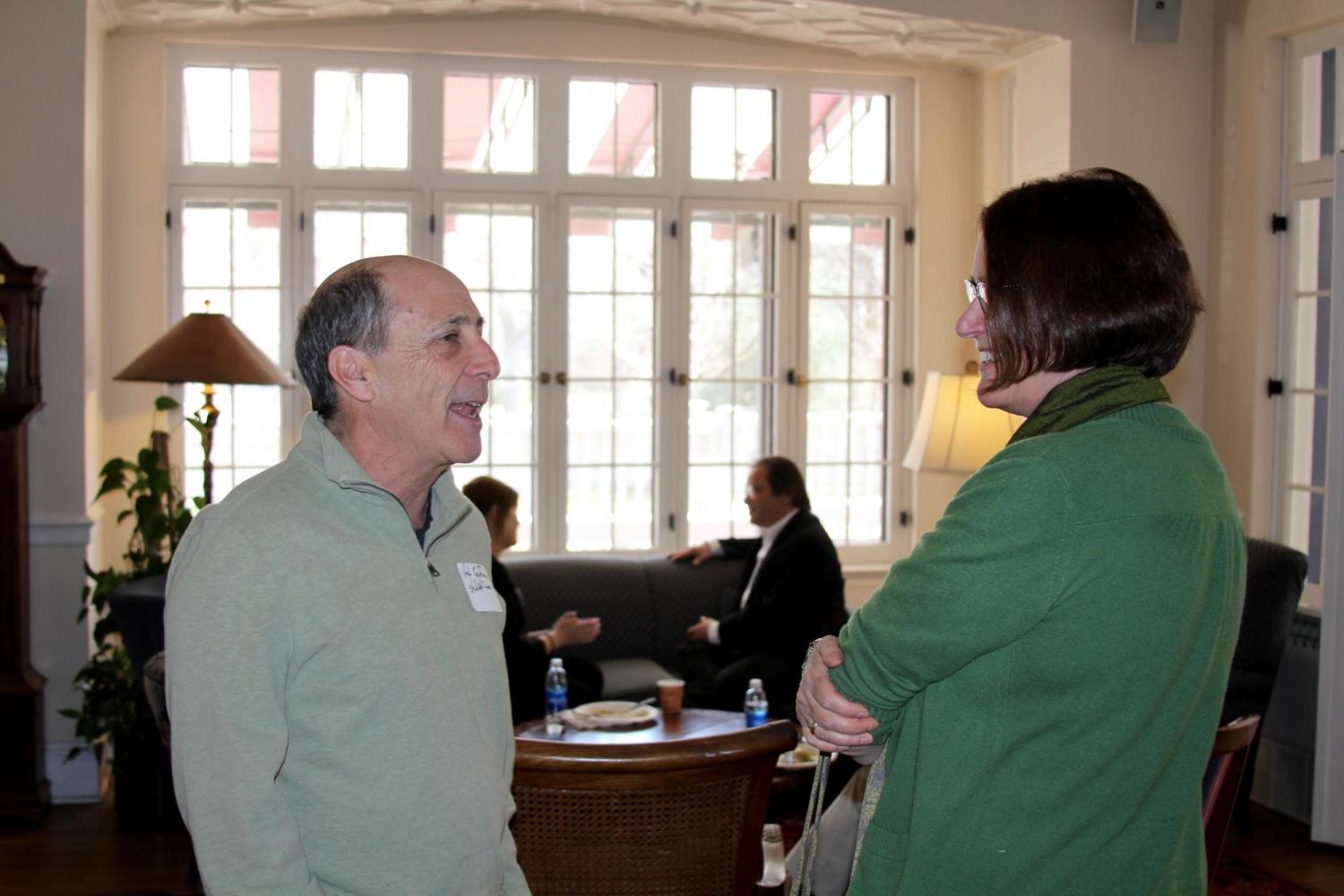 Donor and professor talking to each other during event. 