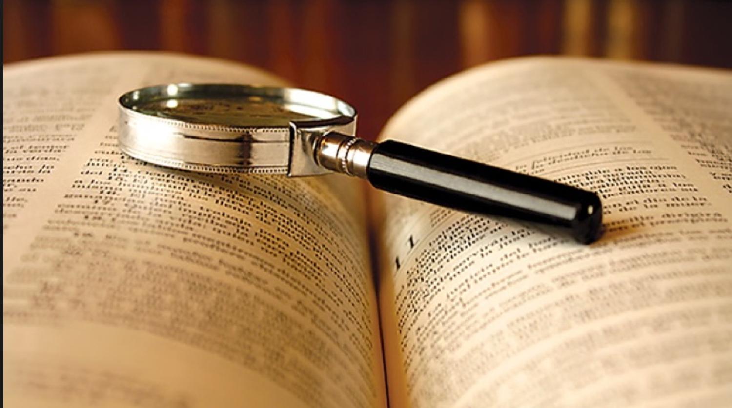 A magnifying glass on an open book